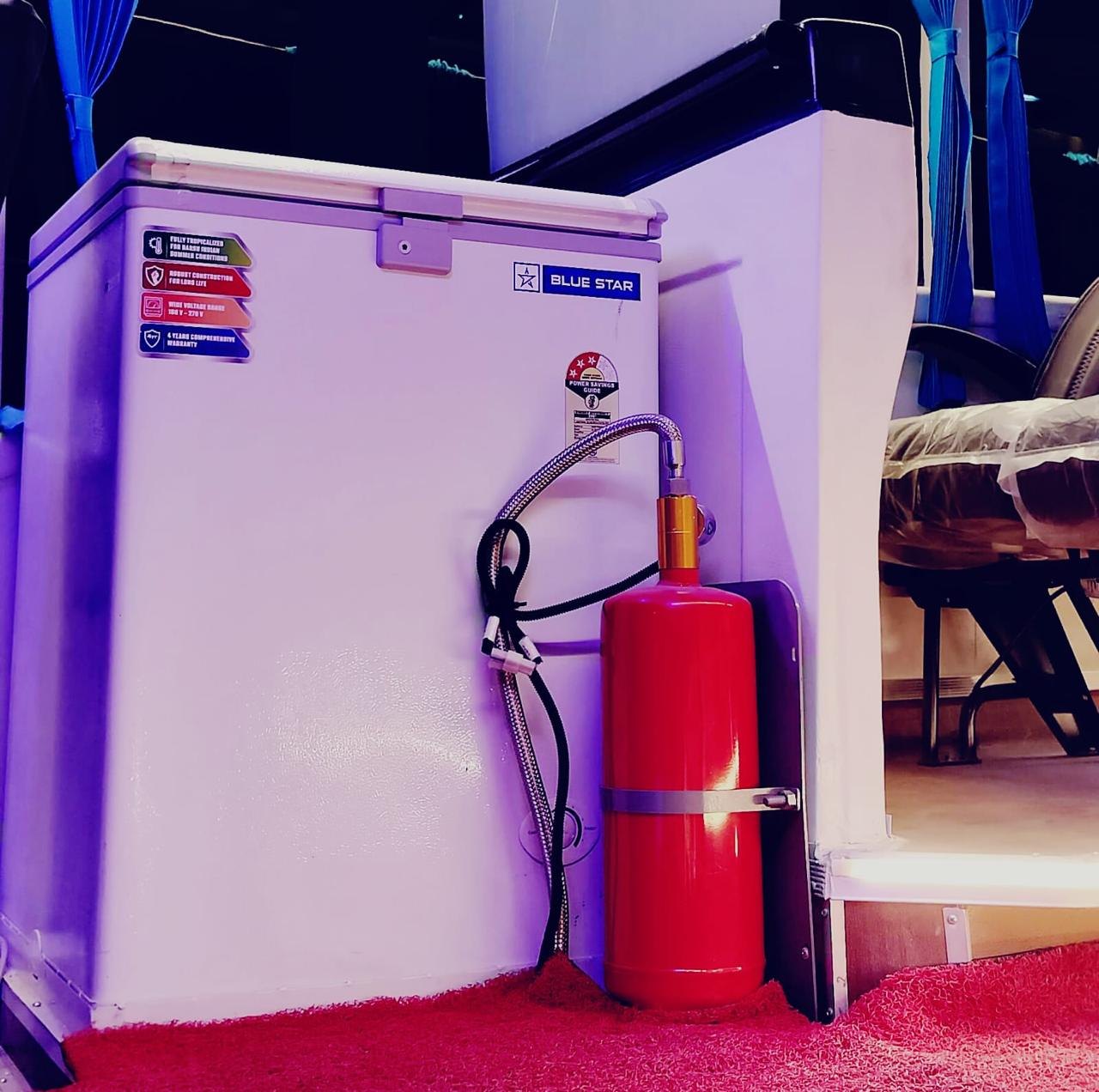 Onboard refrigerator and mounted fire safety cylinder inside a luxury coach