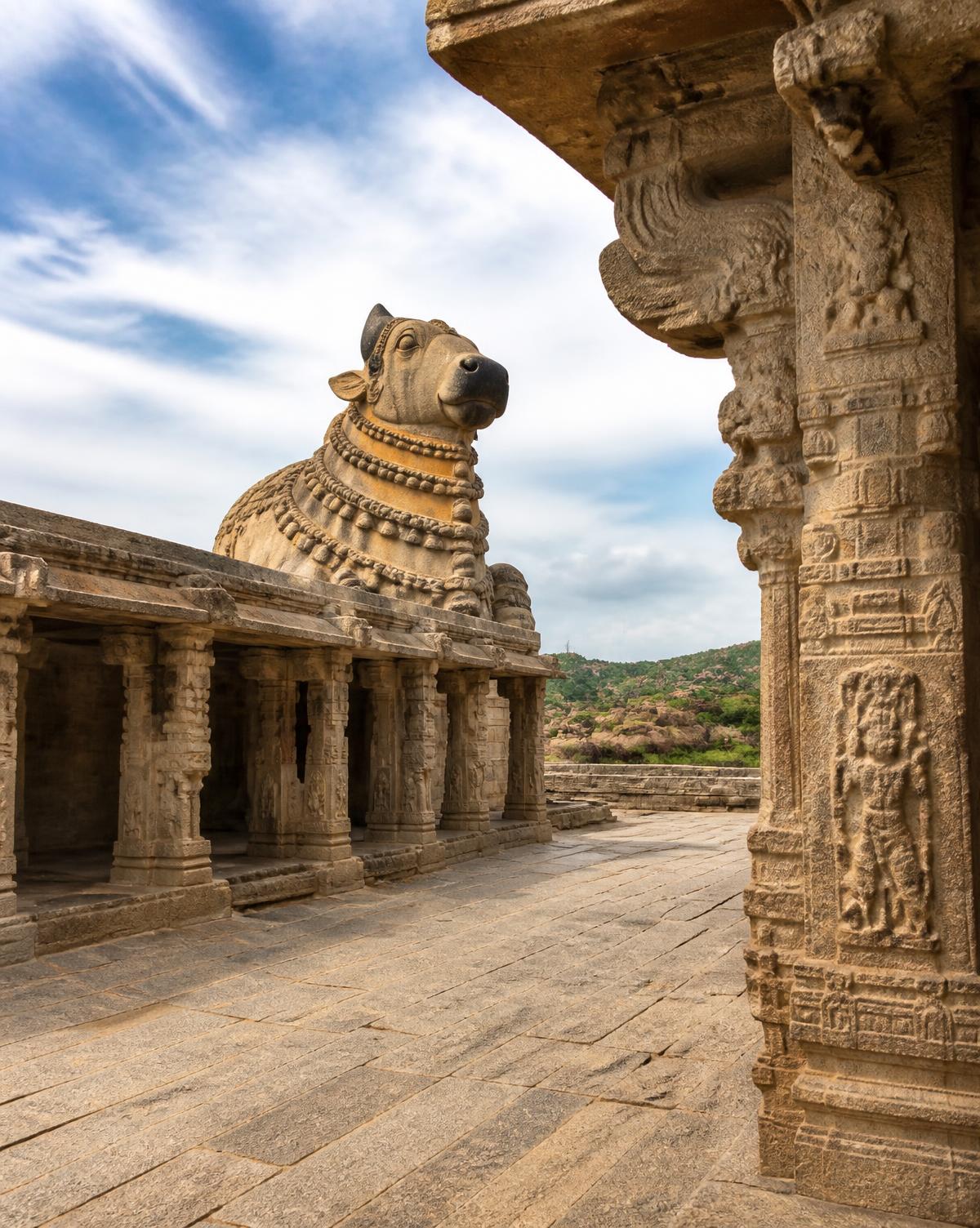 Intricately carved stone pillars and Nandi statue at Lepakshi temple, Andhra Pradesh