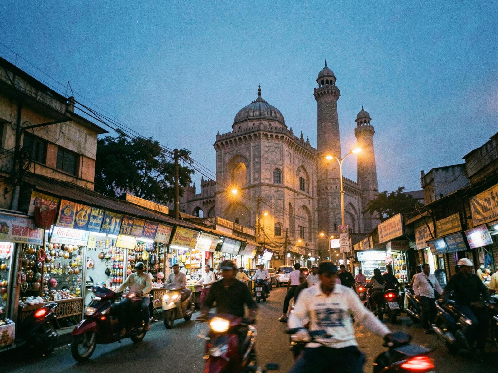 Illuminated historic monument in Hyderabad at blue hour with a busy street
