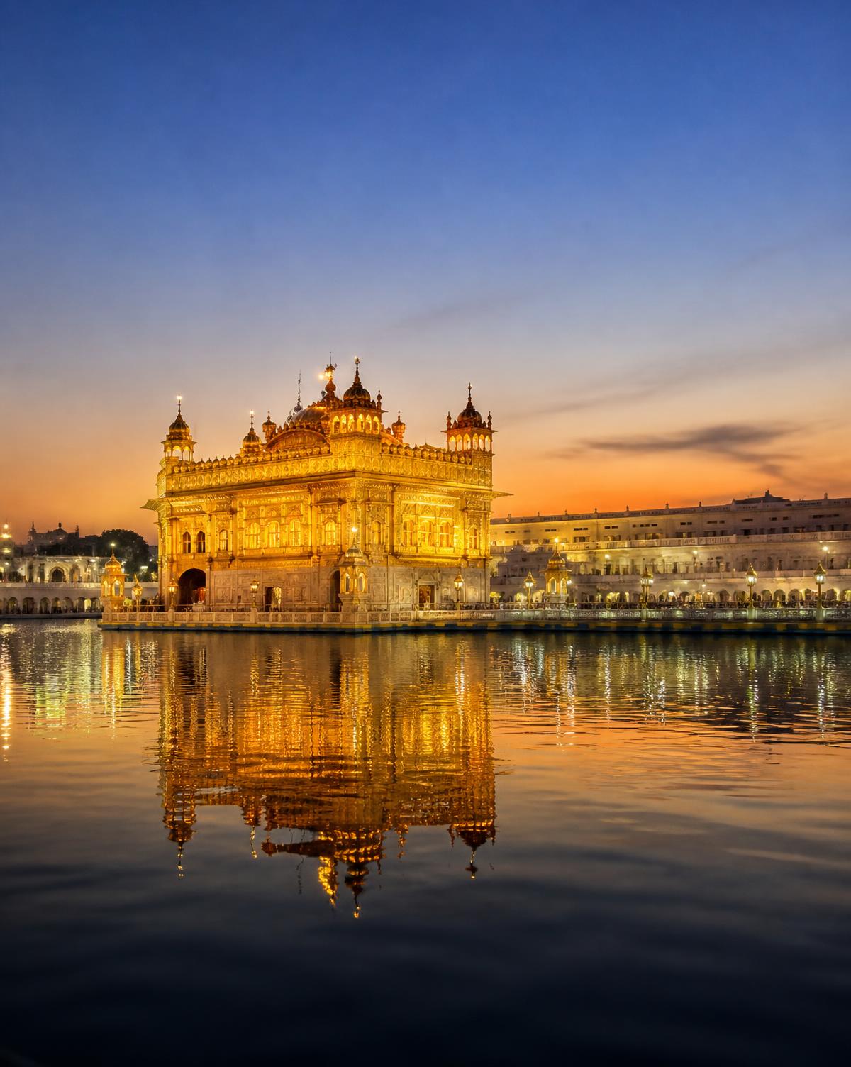 The Golden Temple in Amritsar reflected in the sacred pool at dusk